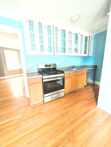 a kitchen with stainless steel appliances a stove a sink and a microwave