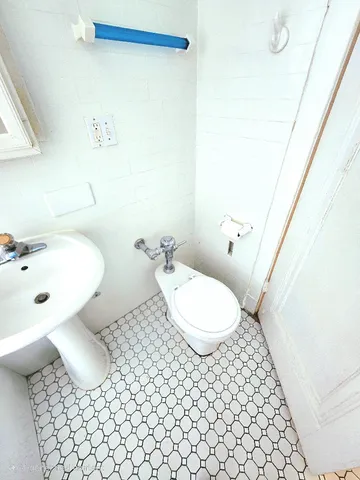 a bathroom with a sink mirror vanity and toilet