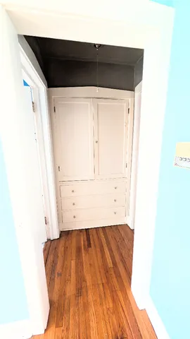 a view of a room with wooden floor