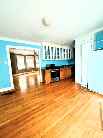 a view of livingroom with kitchen furniture and wooden floor