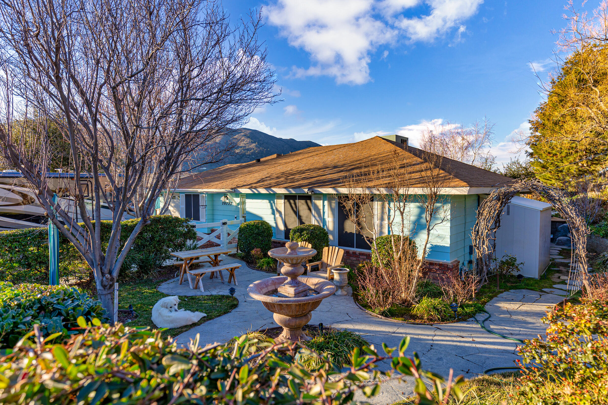 20727 Ridgecrest Drive Tehachapi, CA 93561 - Photo 4 of 27 a view of a patio with table and chairs under an umbrella