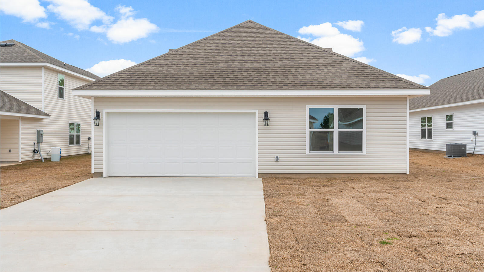 38 Elderberry Street Freeport, FL 32439 - Photo 26 of 34 a front view of a house with a yard and garage