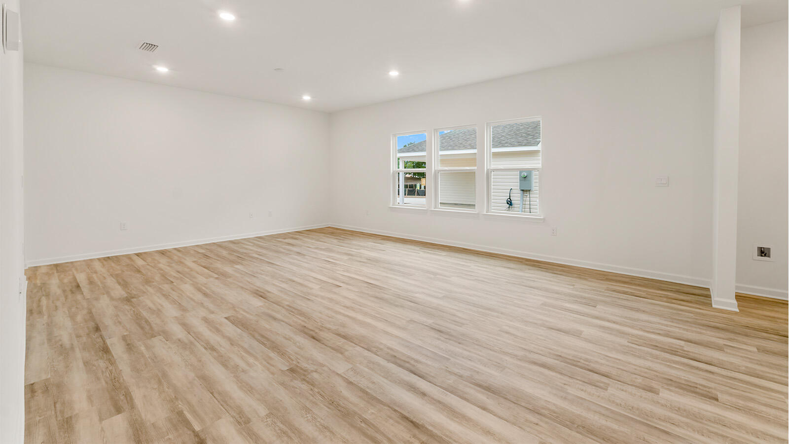 38 Elderberry Street Freeport, FL 32439 - Photo 7 of 34 an empty room with wooden floor and windows