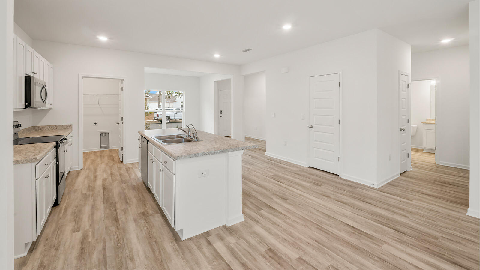 38 Elderberry Street Freeport, FL 32439 - Photo 10 of 34 a kitchen that has a lot of counter space and wooden floor