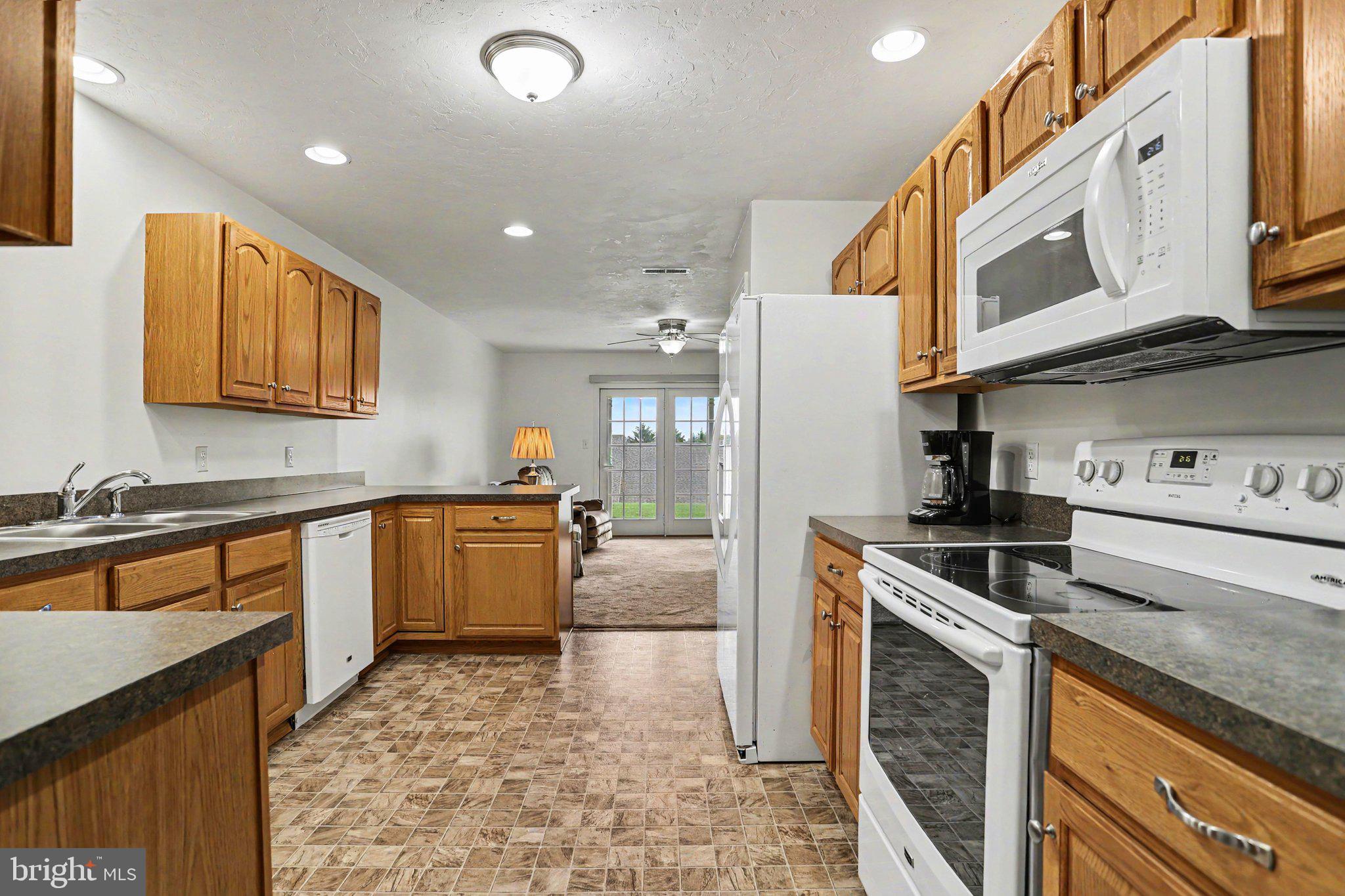 1371 Chami Drive, Unit 166 Spring Grove, PA 17362 - Photo 13 of 28 a large kitchen with stainless steel appliances granite countertop a stove a sink and a microwave