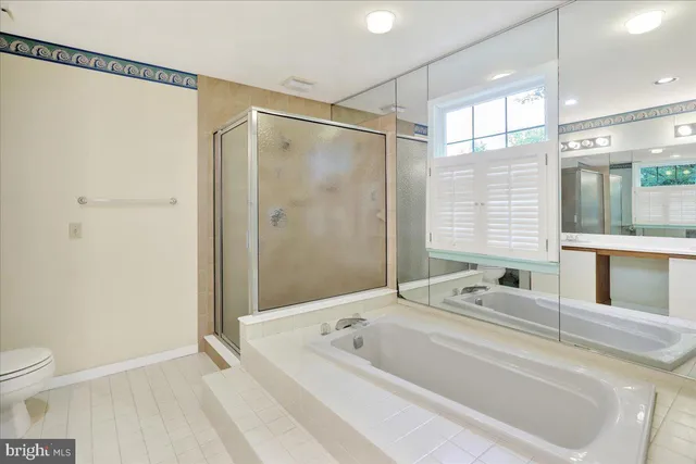 a bathroom with a bathtub a toilet and a shower