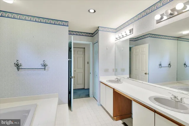 a spacious bathroom with a shower sink and mirror