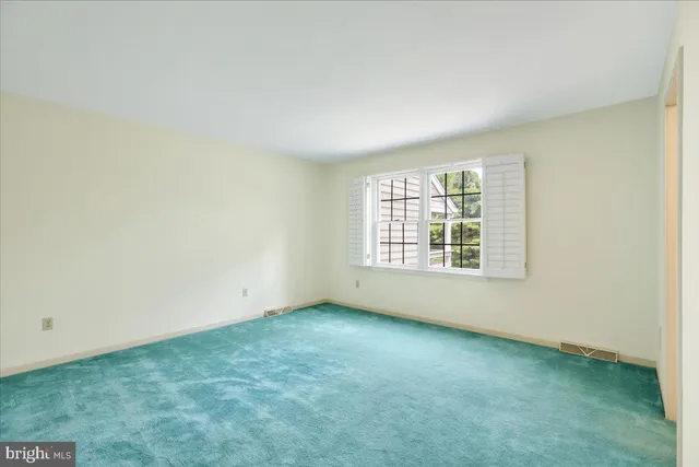 a view of an empty room and closet area