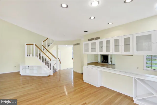 a view of entryway and kitchen with wooden floor
