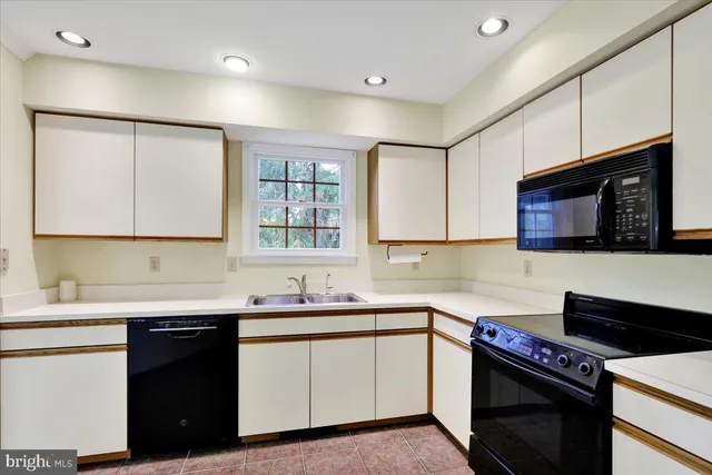 a kitchen with a sink and a stove top oven