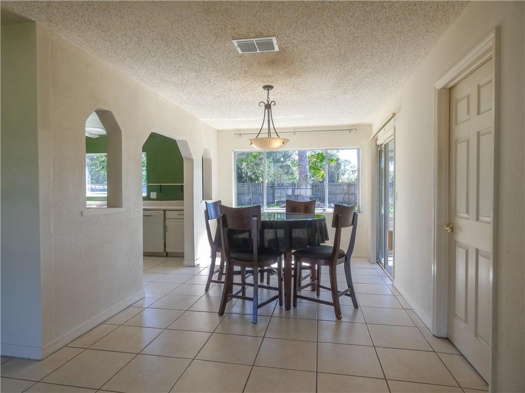2079 Southeast Triumph Road Port St. Lucie, FL 34952 - Photo 11 of 23 a view of a dining room with furniture and window