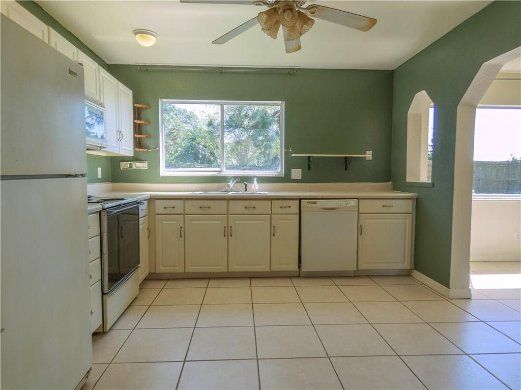2079 Southeast Triumph Road Port St. Lucie, FL 34952 - Photo 14 of 23 a kitchen with a sink a stove cabinets and stainless steel appliances