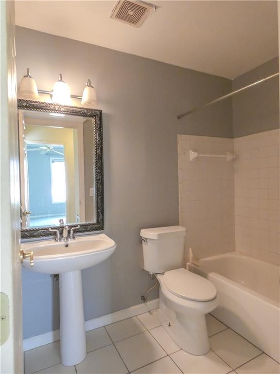2079 Southeast Triumph Road Port St. Lucie, FL 34952 - Photo 17 of 23 a bathroom with a toilet sink and mirror