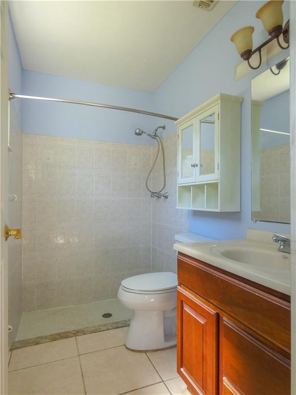 2079 Southeast Triumph Road Port St. Lucie, FL 34952 - Photo 19 of 23 a bathroom with a sink a toilet and shower