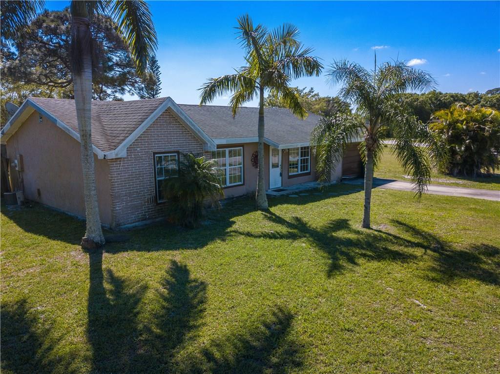 2079 Southeast Triumph Road Port St. Lucie, FL 34952 - Photo 2 of 23 a view of a house with swimming pool next to a yard