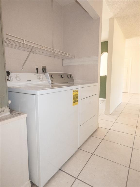 2079 Southeast Triumph Road Port St. Lucie, FL 34952 - Photo 21 of 23 a utility room with dryer and washer