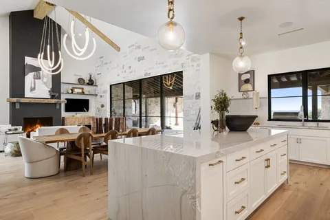 a kitchen with a dining table and chairs