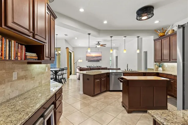 a kitchen with stainless steel appliances granite countertop a stove a sink and a microwave