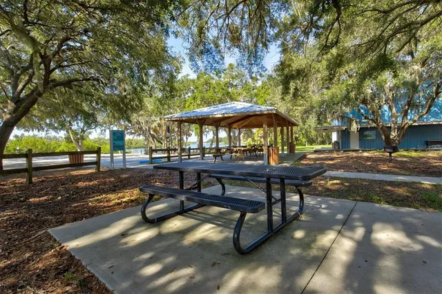 a view of a lake with a table and chairs