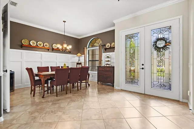 a view of a dining room with furniture and chandelier
