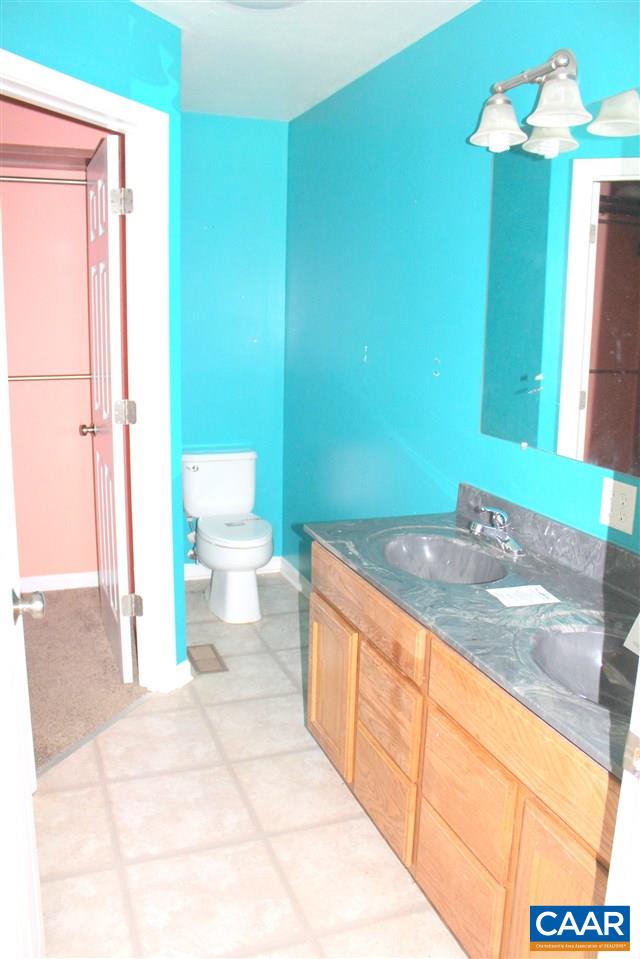 322 Chapel Road Ruckersville, VA 22968 - Photo 8 of 15 a bathroom with a granite countertop sink and a mirror