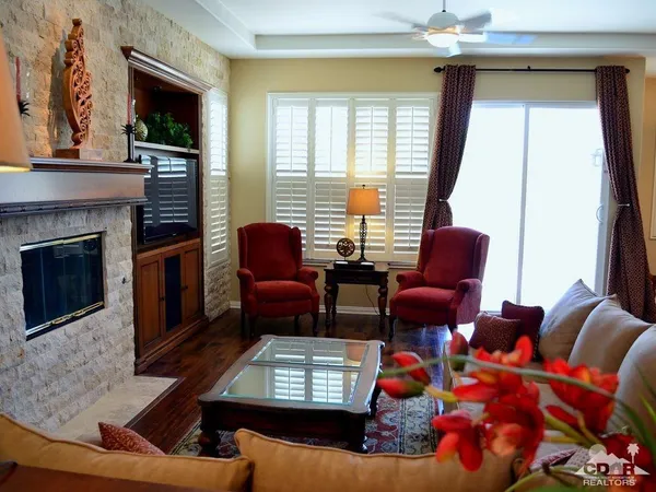 a living room with furniture fireplace and flat screen tv