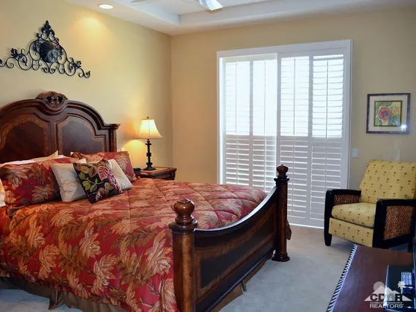 a bed room with a bed and a television