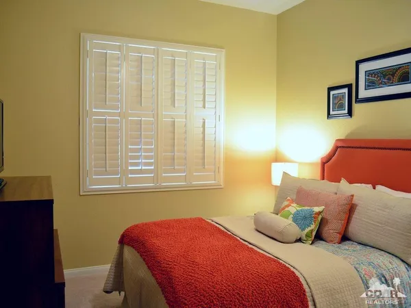 a bedroom with bed and window