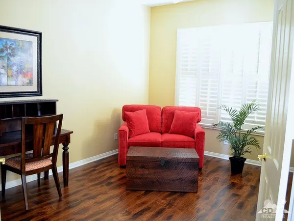 a bedroom with a bed and a potted plant
