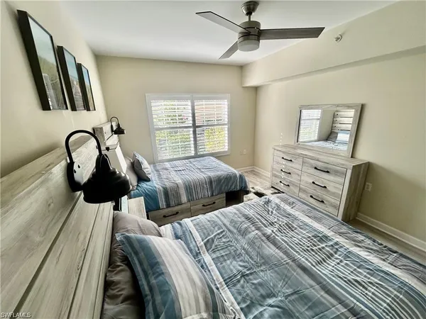 a bedroom with two beds and a dresser