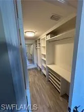 a view of room with stairs and wooden floor