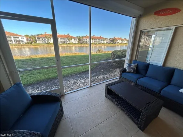 a living room with glass top table and chairs