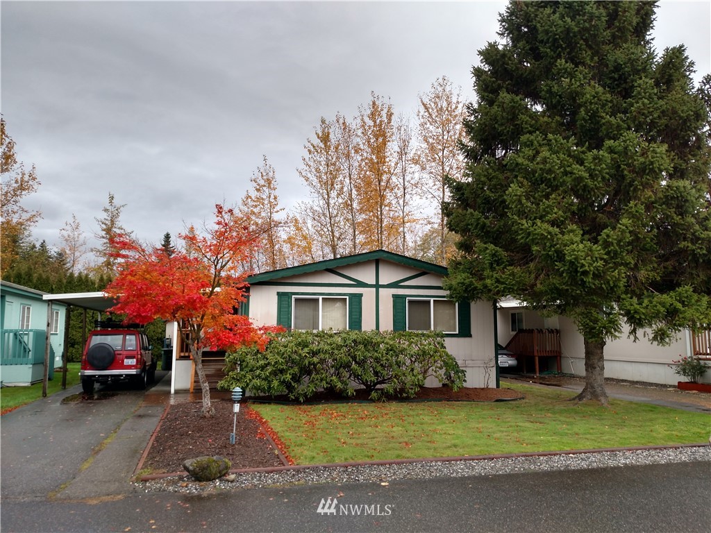 425 Chuckanut Drive North, Unit 4 Bellingham, WA 98229 - Photo 1 of 1 a front view of a house with a garden and tree