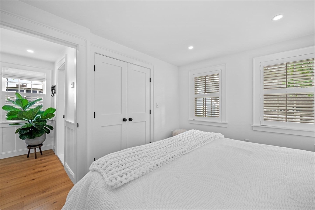31 Franklin Street Marblehead, MA 01945 - Photo 20 of 35 a bedroom with a bed and a potted plant