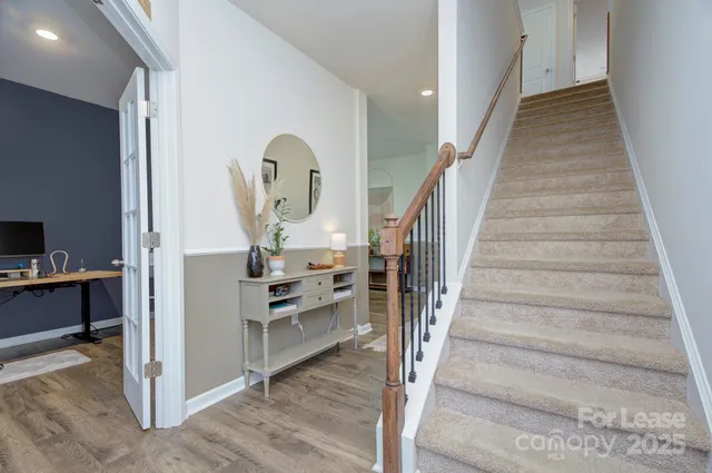 a view of entryway and hall with wooden floor