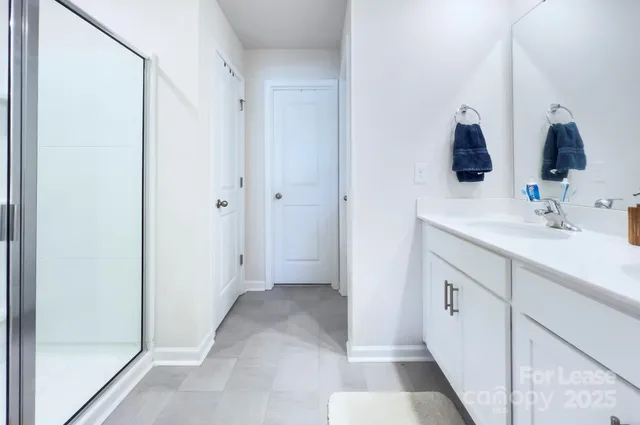a bathroom with a double vanity sink and mirror