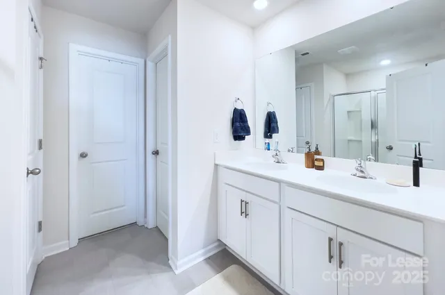a bathroom with a double vanity sink mirror and