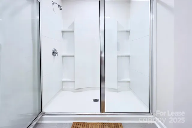 a bathroom with a glass shower door