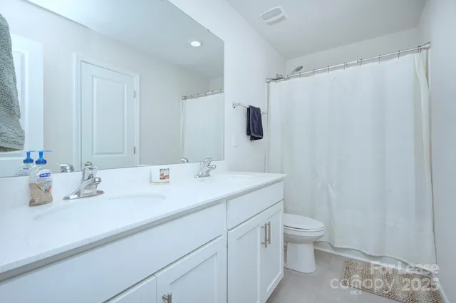 a bathroom with a double vanity sink and mirror