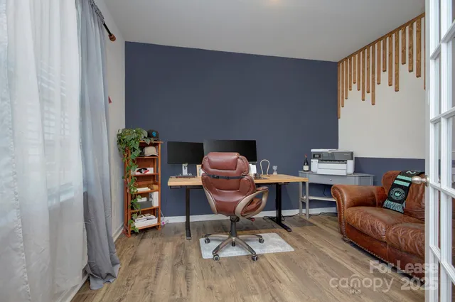 a work room with furniture and wooden floor