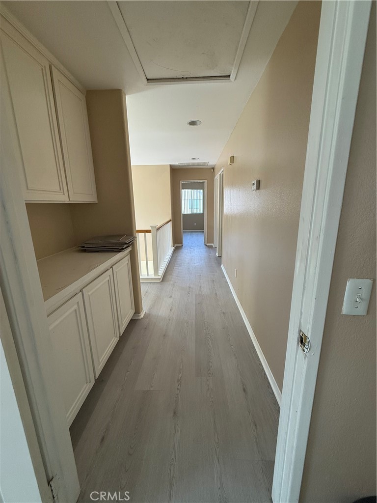 4318-4318 Walnut Street, Unit A Baldwin Park, CA 91706 - Photo 11 of 16 a view of a hallway with wooden floor and staircase
