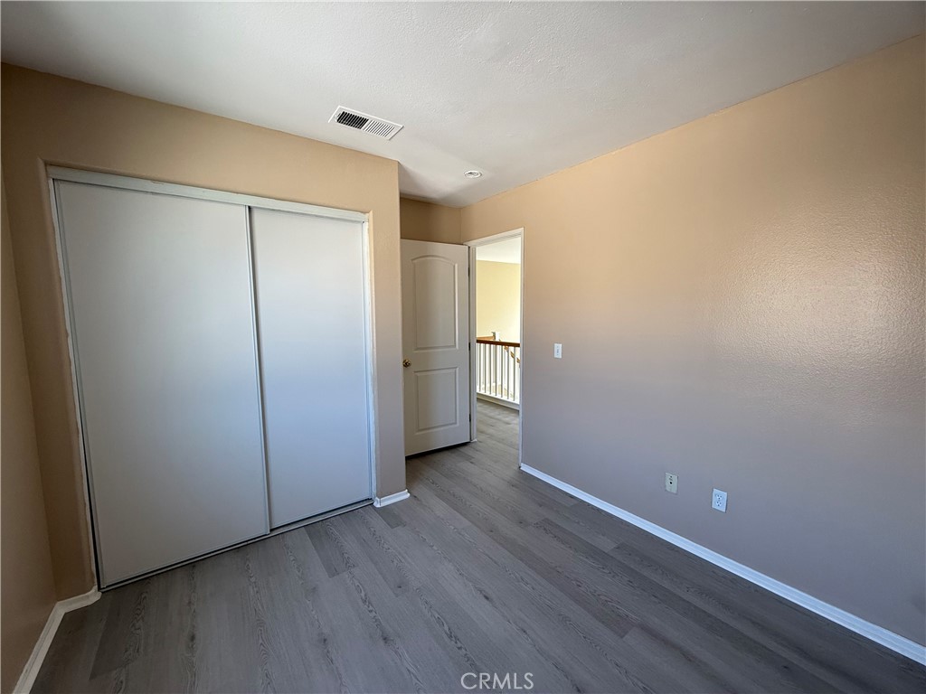 4318-4318 Walnut Street, Unit A Baldwin Park, CA 91706 - Photo 15 of 16 a view of an empty room with closet and wooden floor