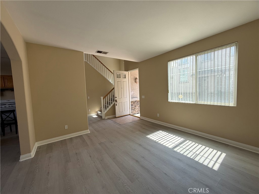 4318-4318 Walnut Street, Unit A Baldwin Park, CA 91706 - Photo 3 of 16 a view of an empty room with wooden floor and a window