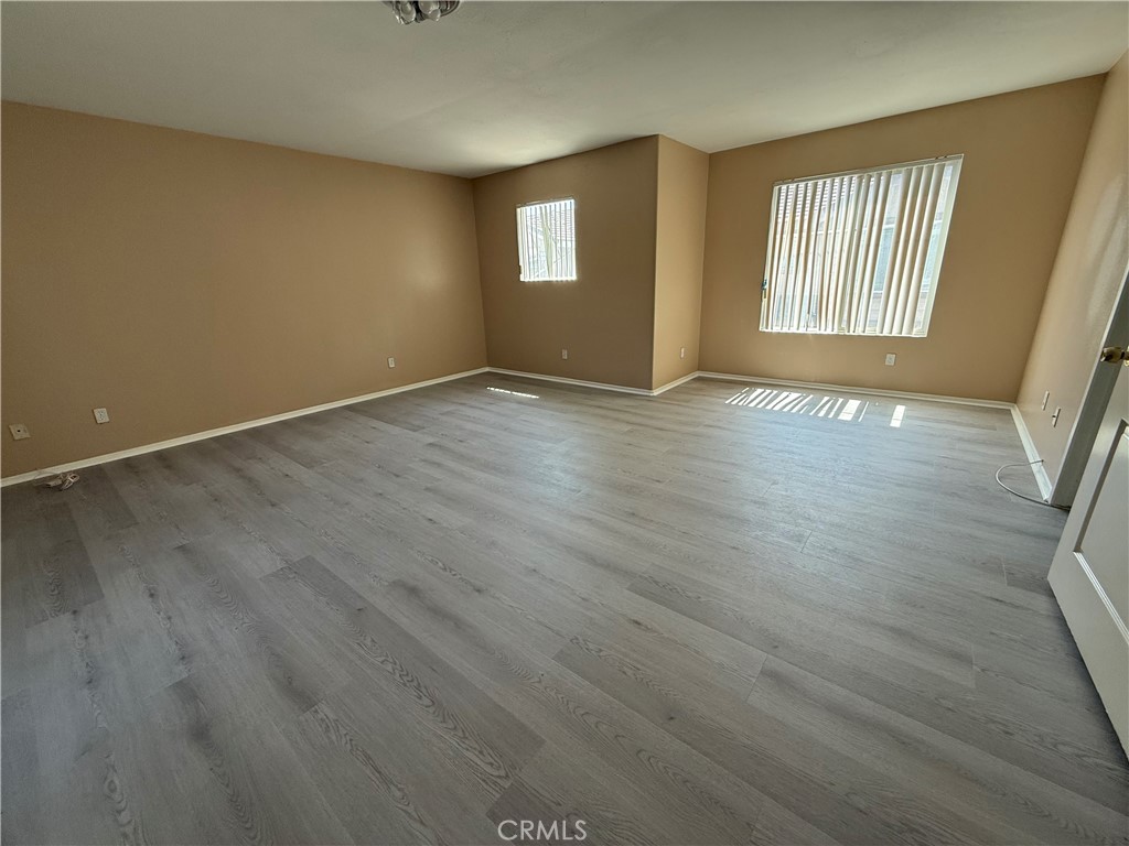 4318-4318 Walnut Street, Unit A Baldwin Park, CA 91706 - Photo 9 of 16 an empty room with wooden floor and windows