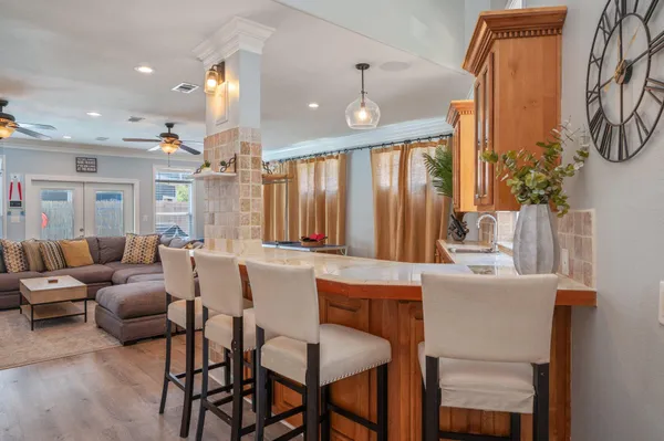 a kitchen with stainless steel appliances granite countertop a stove a sink and a refrigerator