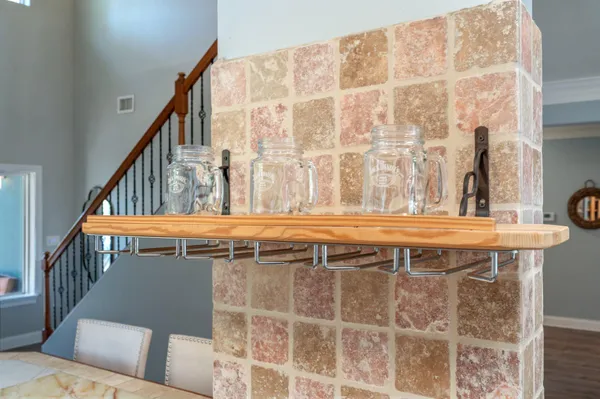 a kitchen with granite countertop white cabinets and a sink