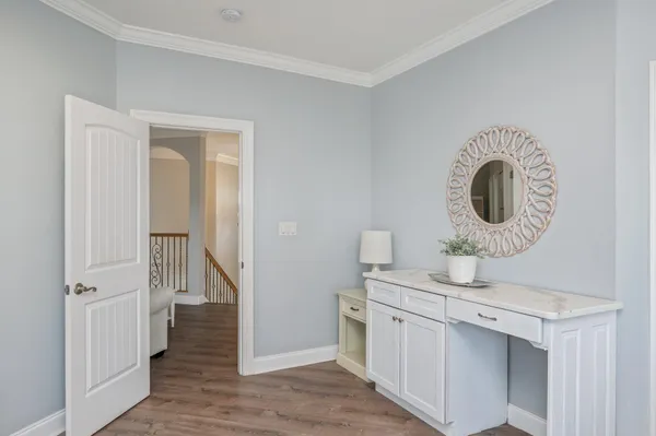 a bedroom with a bed and painting on the wall