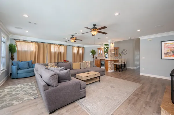 a kitchen with stainless steel appliances granite countertop a sink a window and wooden floor