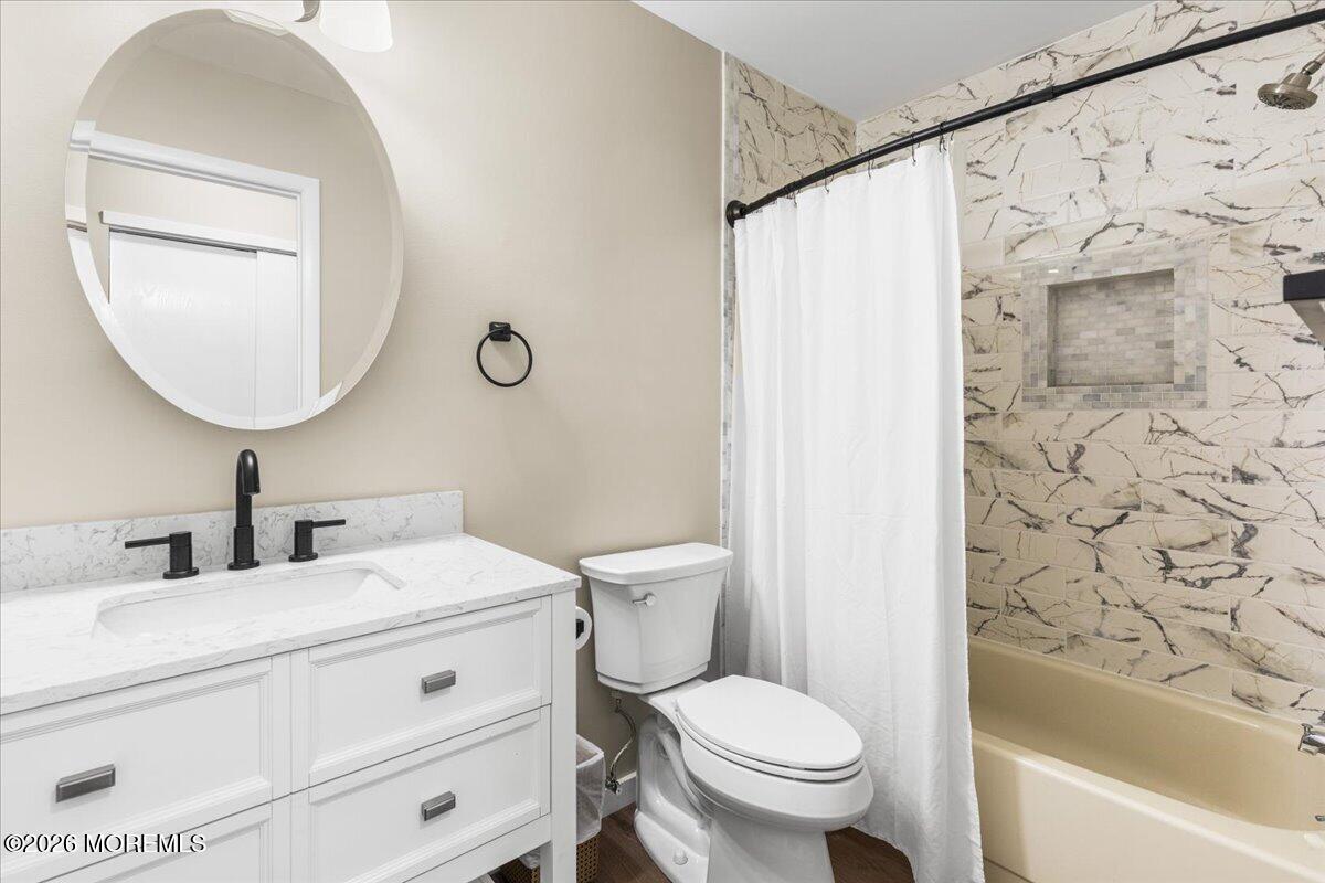 16 D Spring Street, Unit 50 Whiting, NJ 08759 - Photo 22 of 28 a bathroom with a toilet sink and mirror