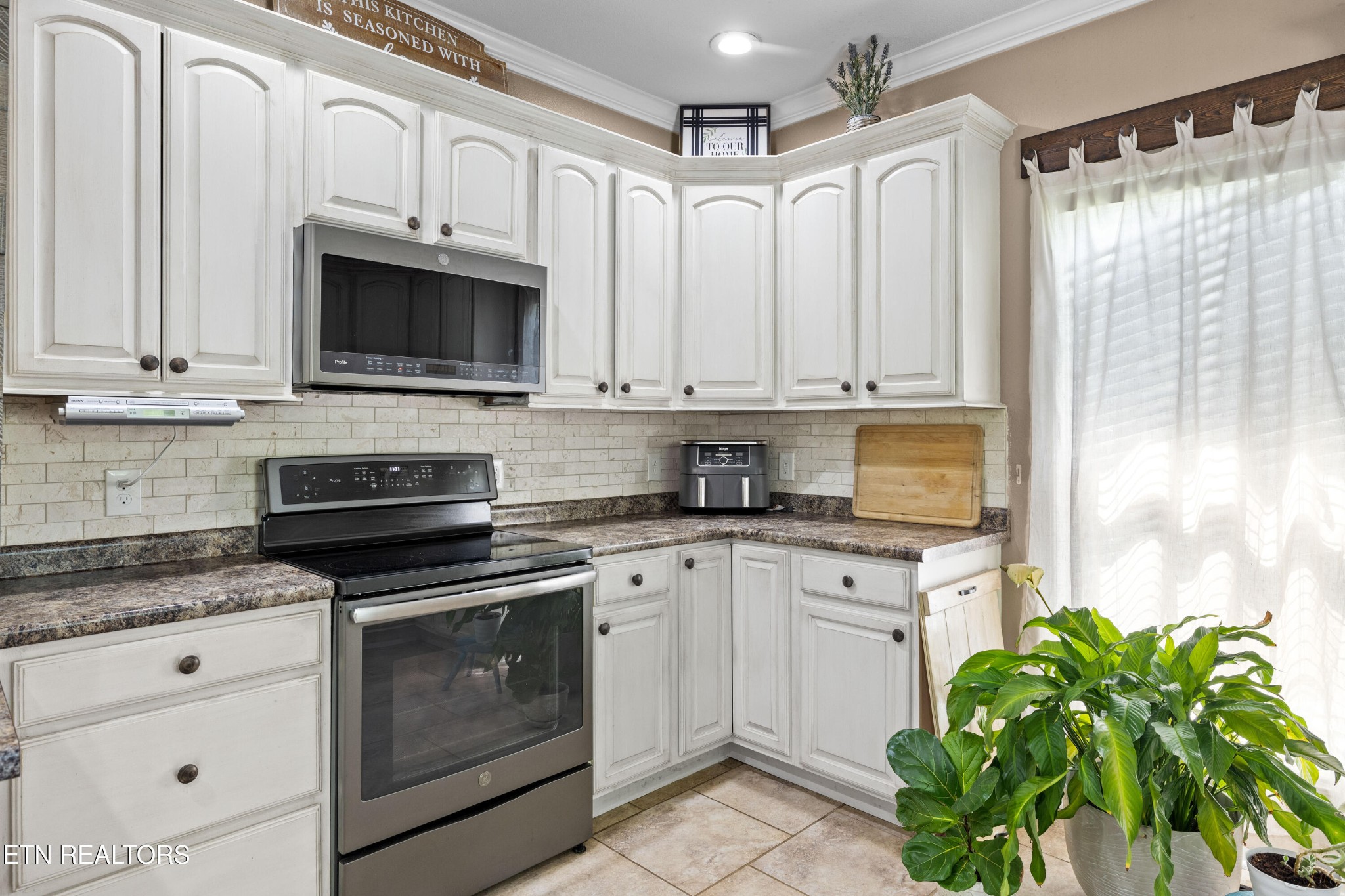 349 Rudd Hollow Road Townsend, TN 37882 - Photo 17 of 52 a kitchen with stainless steel appliances white cabinets and a stove top oven